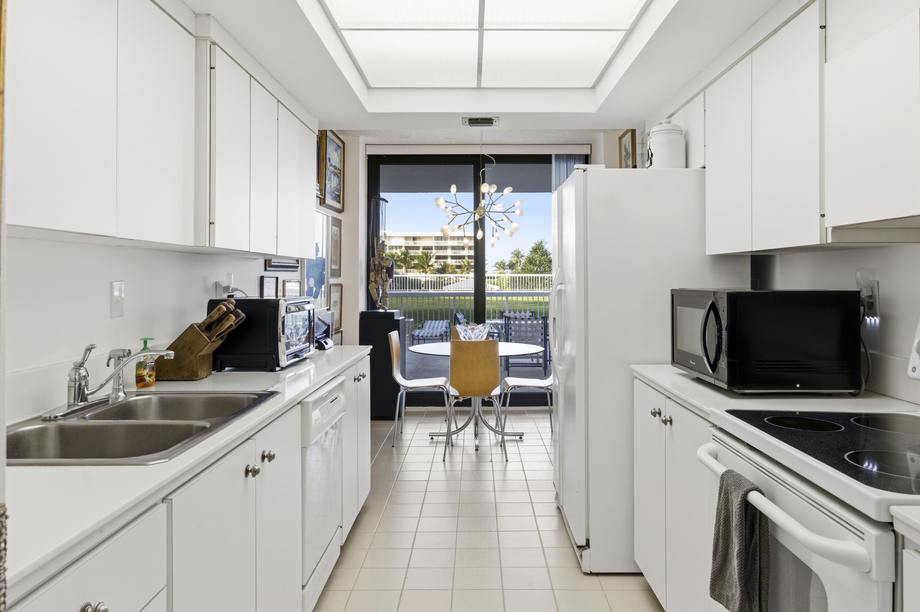 3300 South Ocean Boulevard, Unit 103S Palm Beach, FL 33480 - Photo 7 of 20 a kitchen with a sink appliances and cabinets