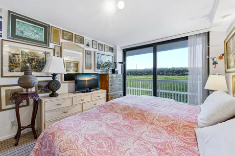 a bedroom with a bed and glass door