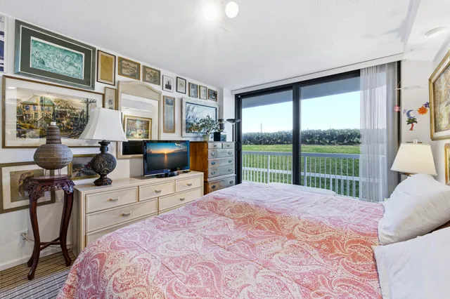 a bedroom with a bed and glass door