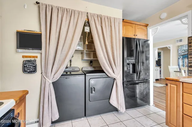 a view of washer and dryer with wooden floor