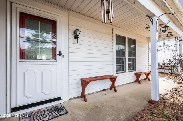 a bench is sitting in front of a white house