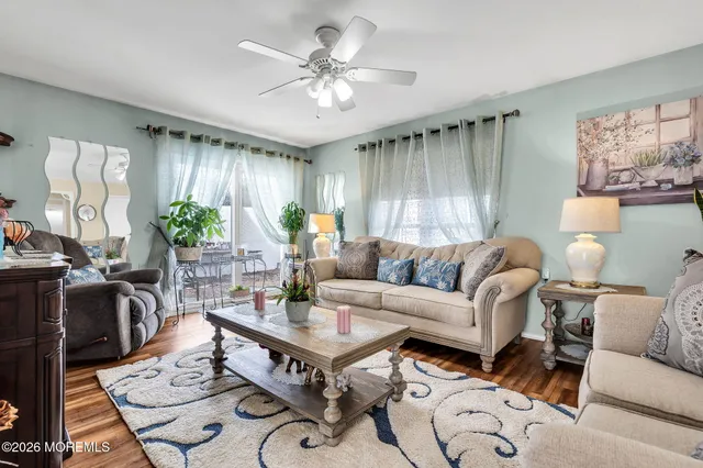 a living room with furniture a chandelier and a window