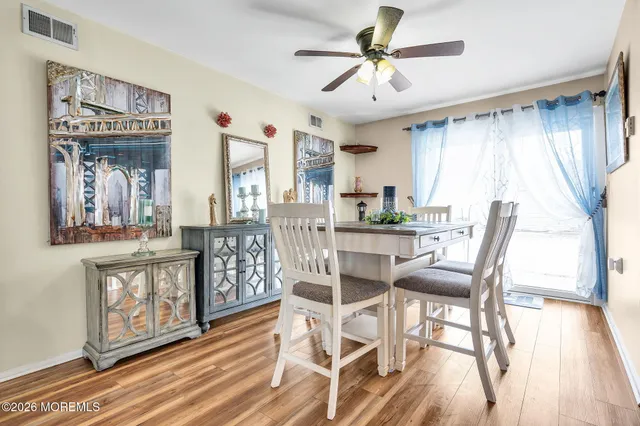 a view of a dining room with furniture window and wooden floor