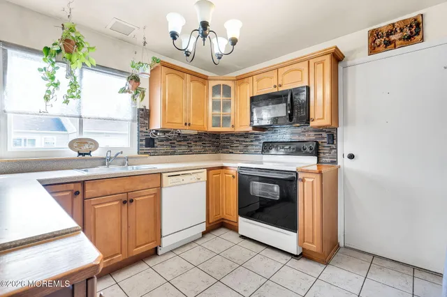 a kitchen with stainless steel appliances granite countertop a sink and a stove