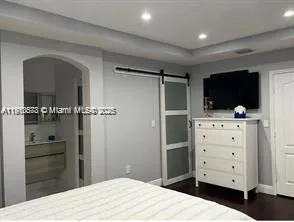 a bedroom with a bed and a flat screen tv