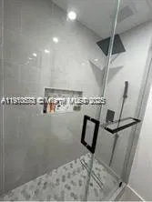 a white toilet sitting next to a small bathroom