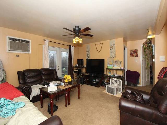 4839 West Engle Road, Unit 2D Alsip, IL 60803 - Photo 2 of 16 a living room with furniture a ceiling fan and a flat screen tv