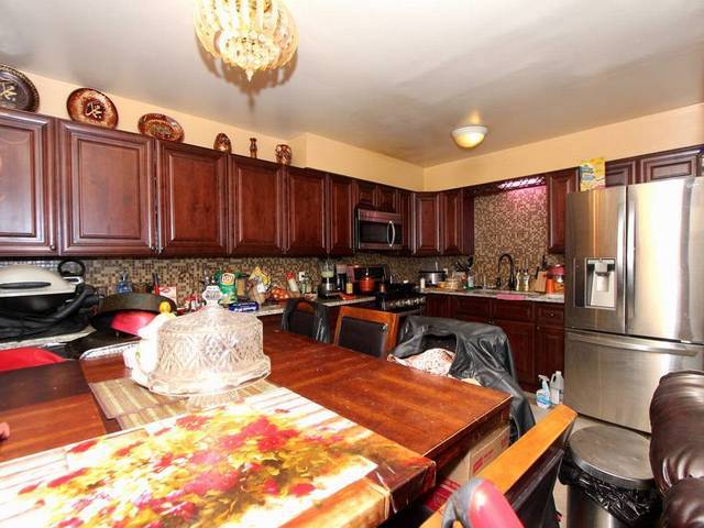 4839 West Engle Road, Unit 2D Alsip, IL 60803 - Photo 5 of 16 a kitchen with a refrigerator and a stove top oven