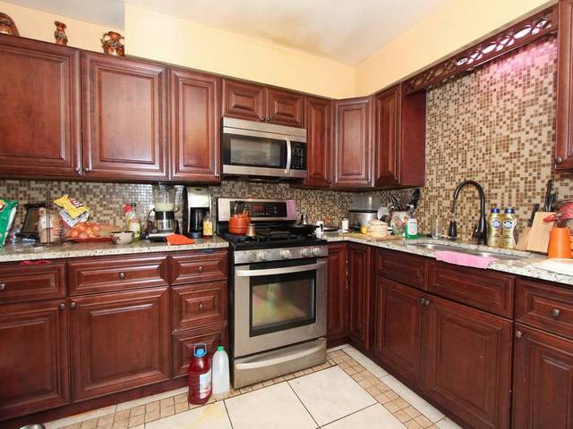 4839 West Engle Road, Unit 2D Alsip, IL 60803 - Photo 7 of 16 a kitchen with stainless steel appliances granite countertop a sink stove and microwave