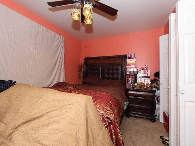 4839 West Engle Road, Unit 2D Alsip, IL 60803 - Photo 8 of 16 a bedroom with a bed and a chandelier