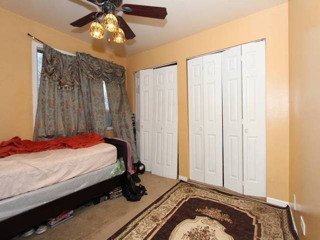 4839 West Engle Road, Unit 2D Alsip, IL 60803 - Photo 10 of 16 a bedroom with a bed and a chandelier