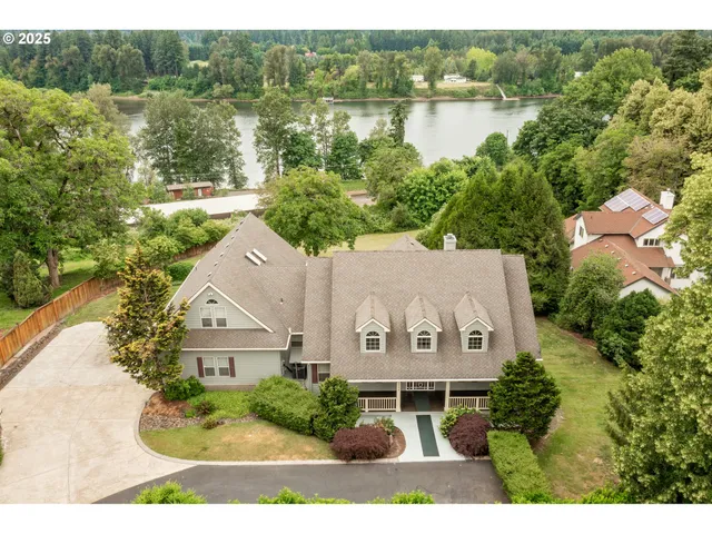 an aerial view of a house with garden space and lake view