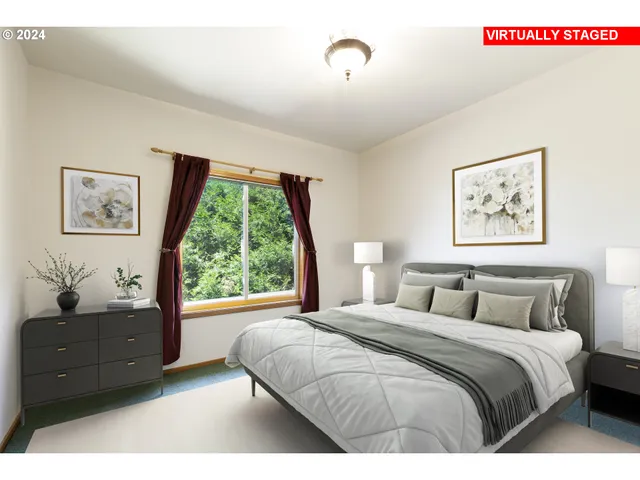 a bedroom with a large bed and a large window