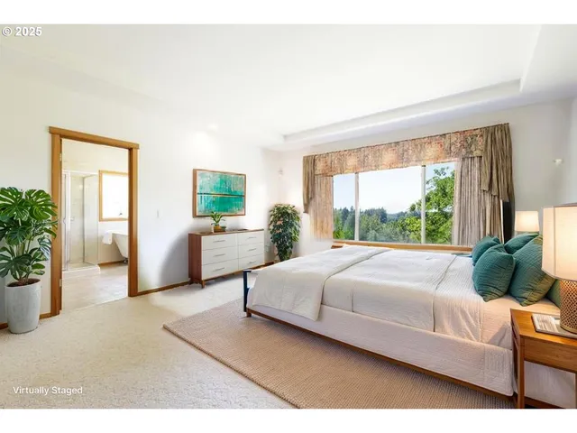 a spacious bedroom with a bed and a window