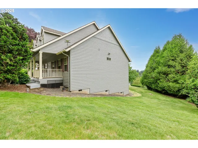 a view of a green field with wooden fence