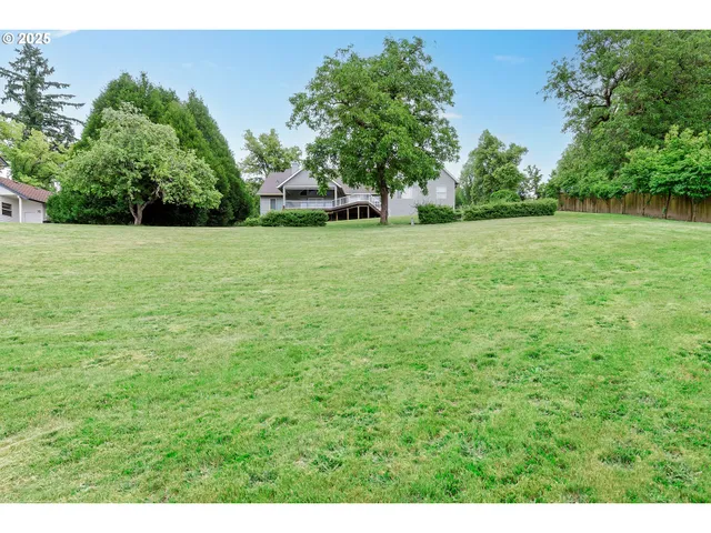 an aerial view of residential houses with outdoor space and lake view