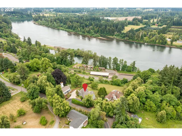 an aerial view of lake residential house with outdoor space and swimming pool