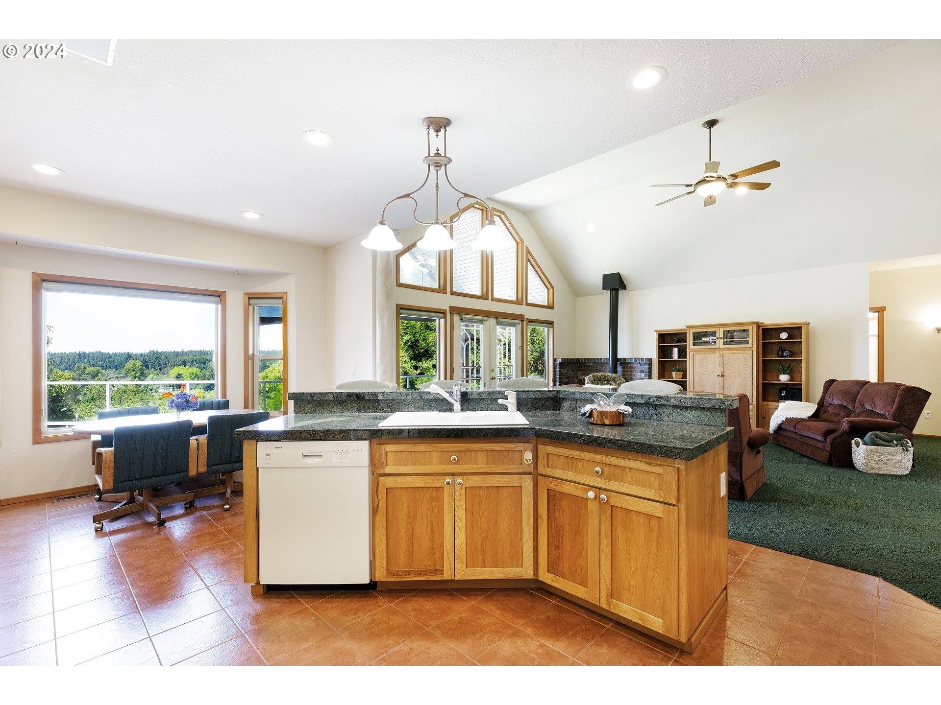 10202 South New Era Road Canby, OR 97013 - Photo 7 of 48 a kitchen with a stove a sink dishwasher and a dining table with garden view