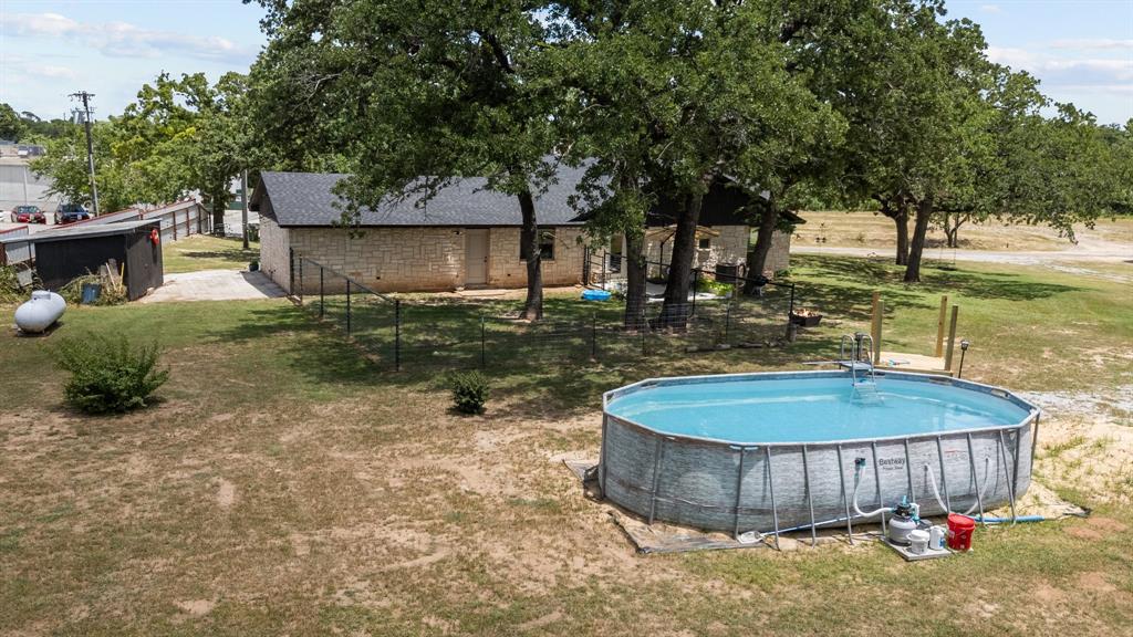 220 South Ash Street Springtown, TX 76082 - Photo 15 of 40 a view of a backyard with water fountain