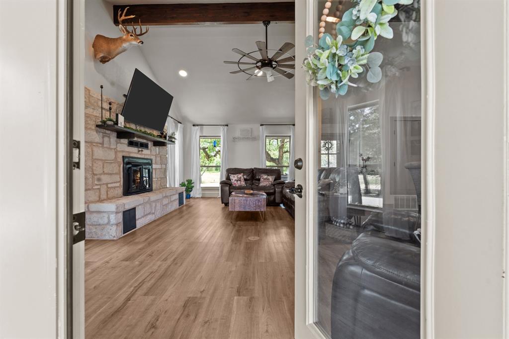 220 South Ash Street Springtown, TX 76082 - Photo 17 of 40 a living room with furniture and a fireplace