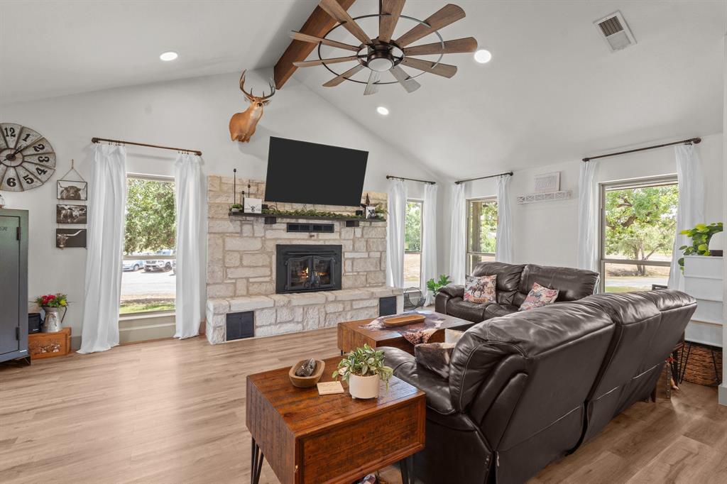 220 South Ash Street Springtown, TX 76082 - Photo 19 of 40 a living room with fireplace furniture and a flat screen tv