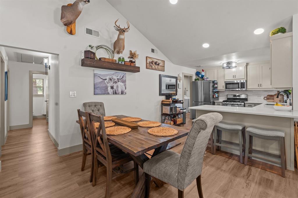 220 South Ash Street Springtown, TX 76082 - Photo 21 of 40 a view of a dining room with furniture and wooden floor