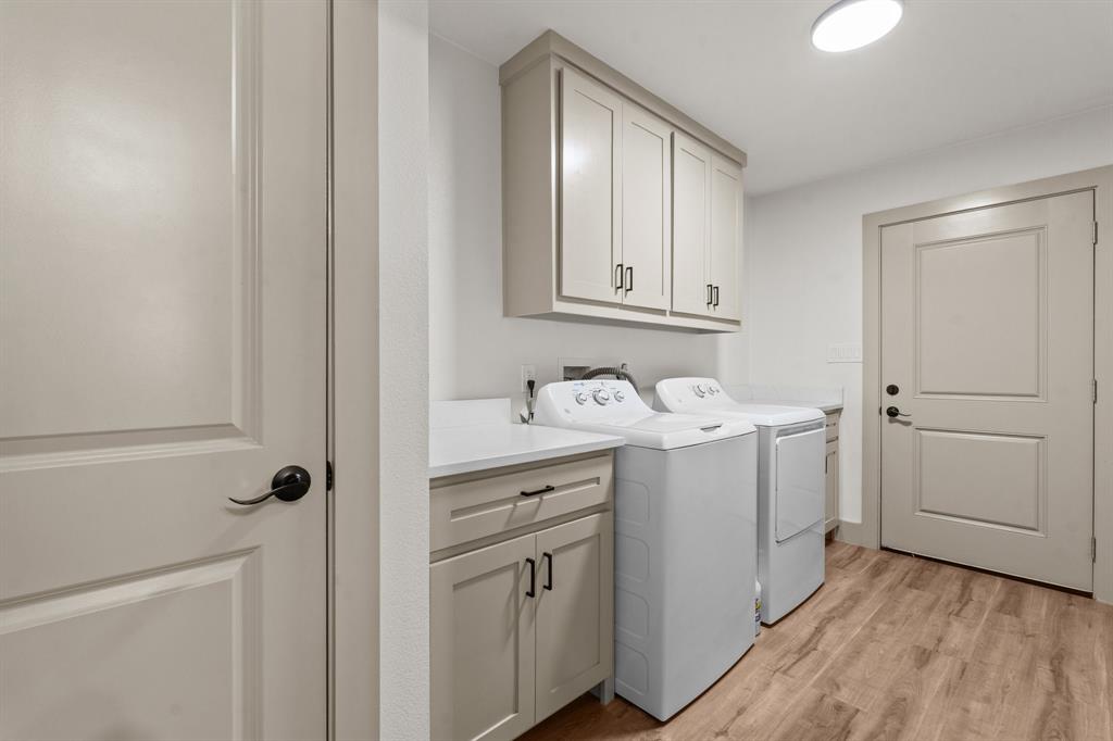 220 South Ash Street Springtown, TX 76082 - Photo 24 of 40 a utility room with cabinets washer and dryer