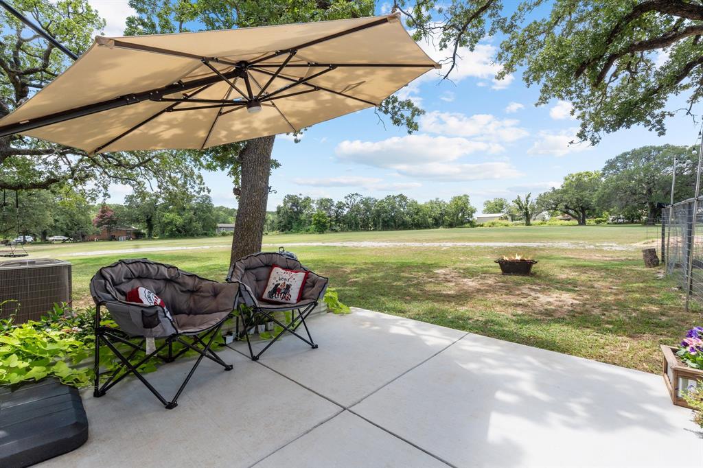 220 South Ash Street Springtown, TX 76082 - Photo 37 of 40 a view of a lake with a table and chairs under an umbrella