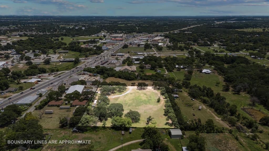 220 South Ash Street Springtown, TX 76082 - Photo 38 of 40 an aerial view of residential building with green space