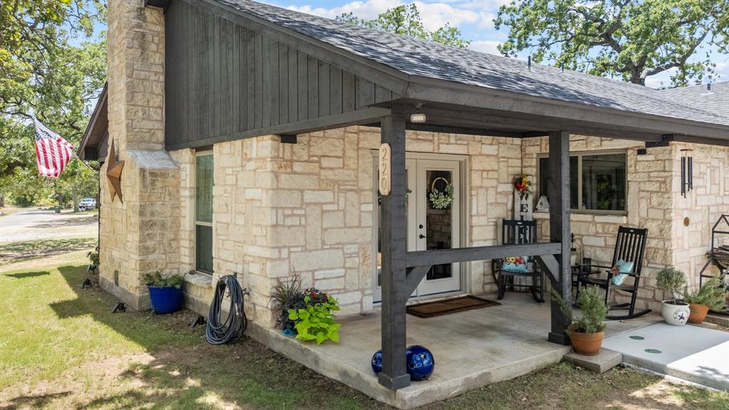 220 South Ash Street Springtown, TX 76082 - Photo 5 of 40 a front view of a house with outdoor seating