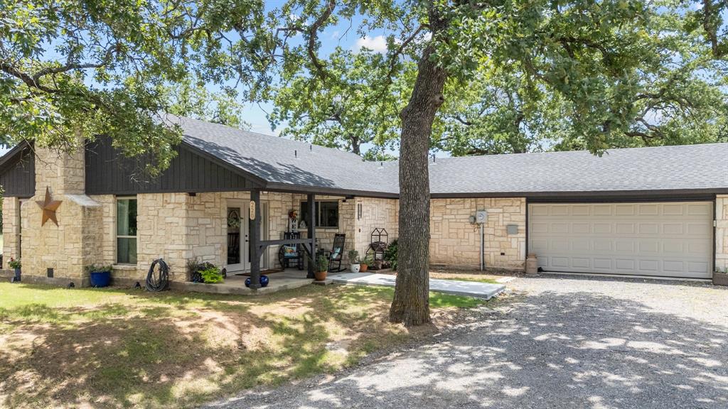 220 South Ash Street Springtown, TX 76082 - Photo 8 of 40 a front view of a house with a yard