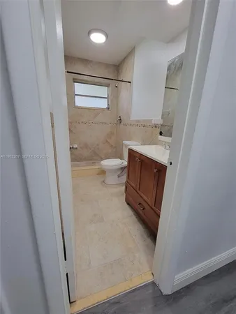 a bathroom with a sink vanity and mirror
