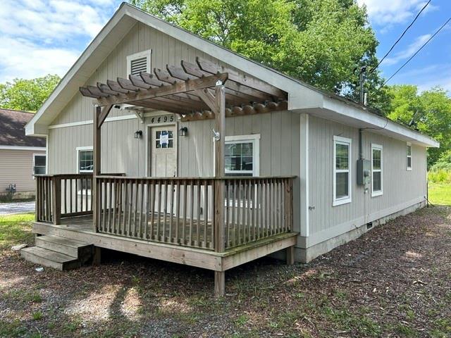 4495 Calhoun Road Northeast Rome, GA 30161 - Photo 1 of 14 a view of a house with a yard and deck