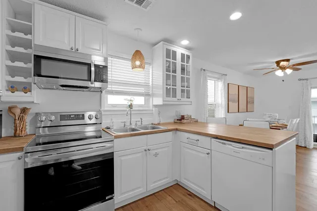 a kitchen with stainless steel appliances granite countertop a stove a sink and a refrigerator