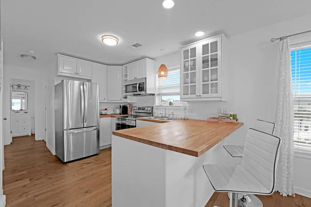 a bedroom with a bed and painting on the wall
