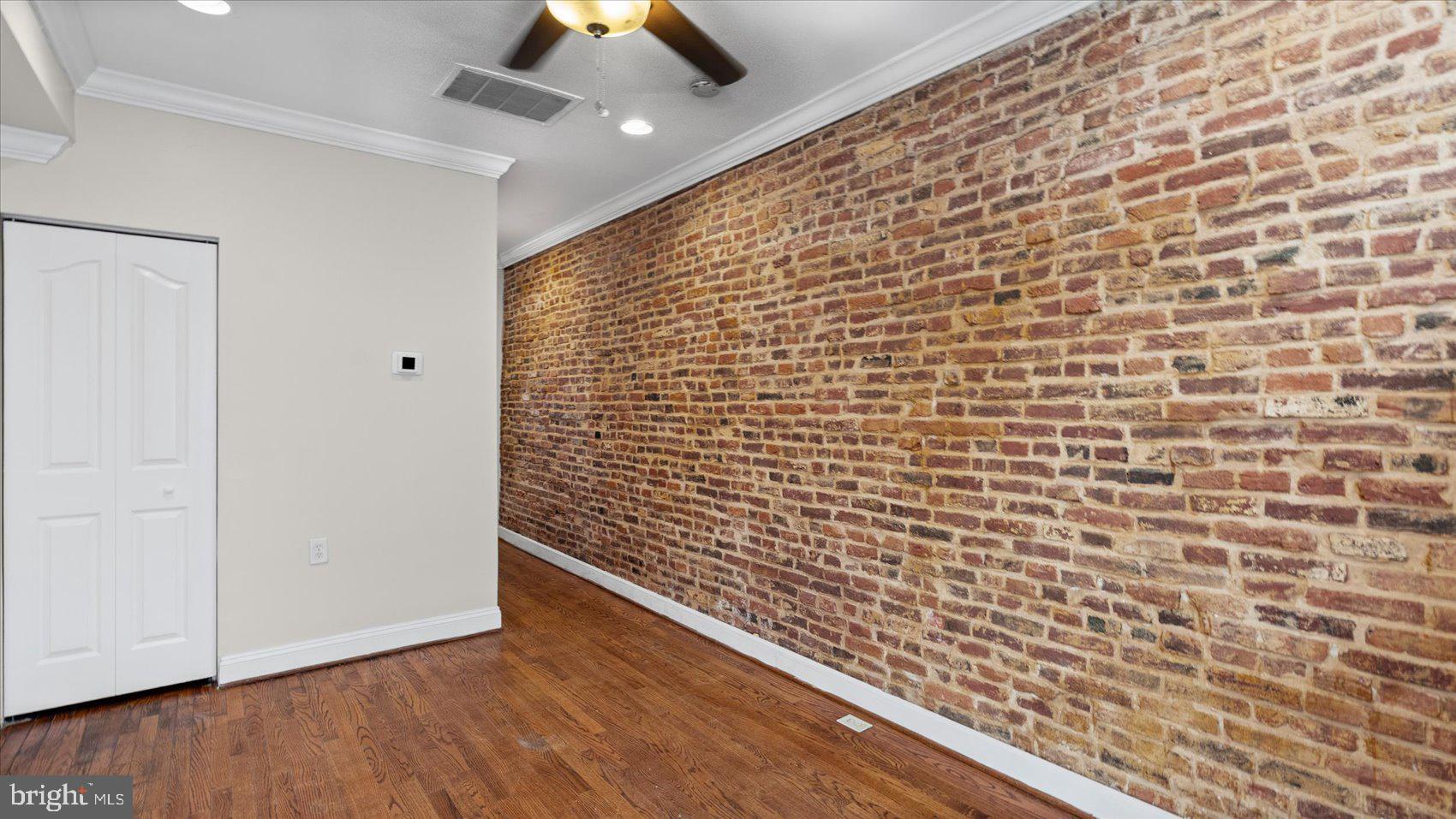 847 Carroll Street Baltimore, MD 21230 - Photo 3 of 33 Charming exposed brick accent wall.