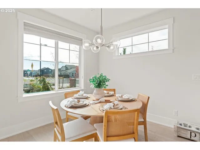 a dining room with furniture a chandelier and window