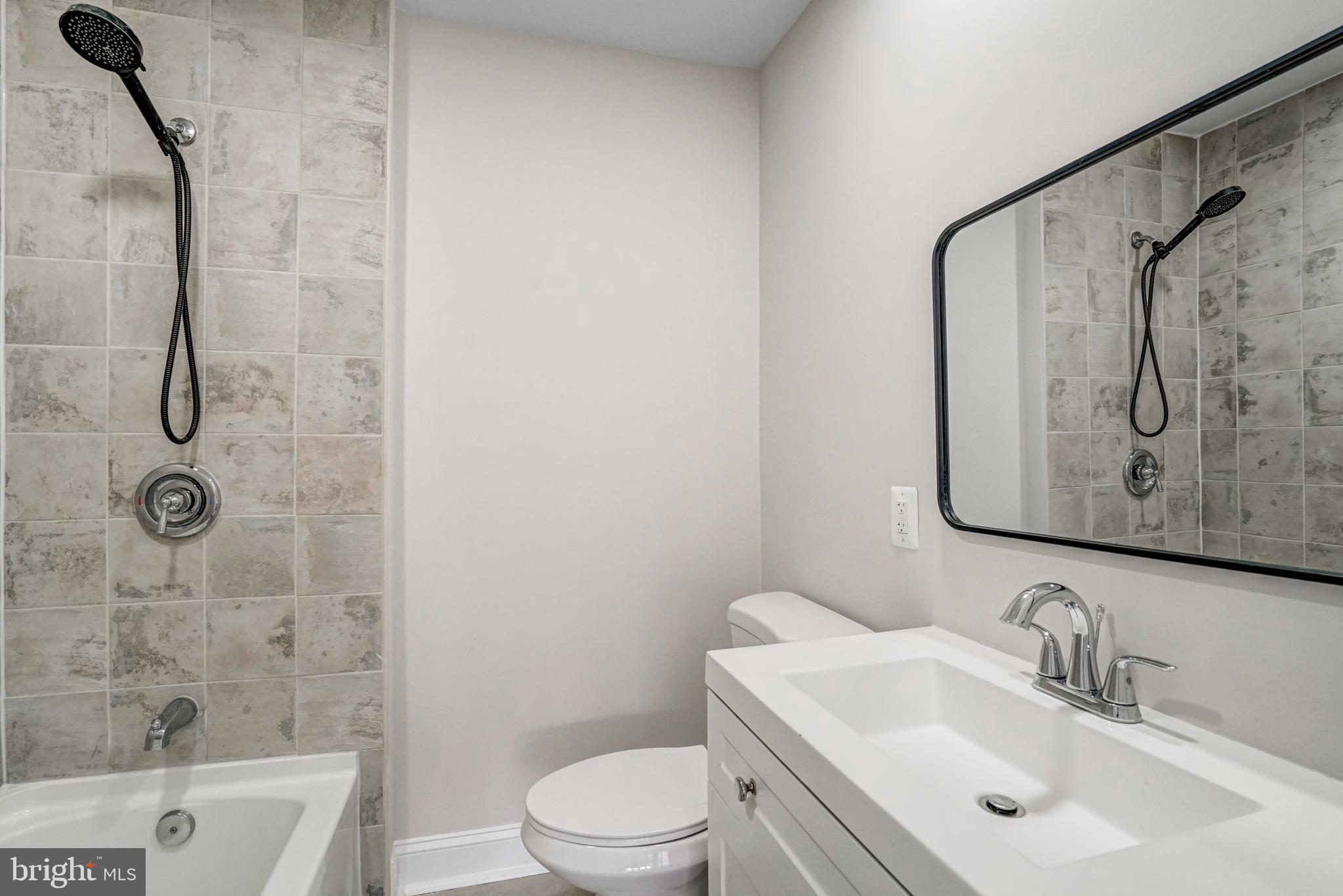 8941 Burke Lake Road Springfield, VA 22151 - Photo 12 of 34 a bathroom with a sink toilet and shower