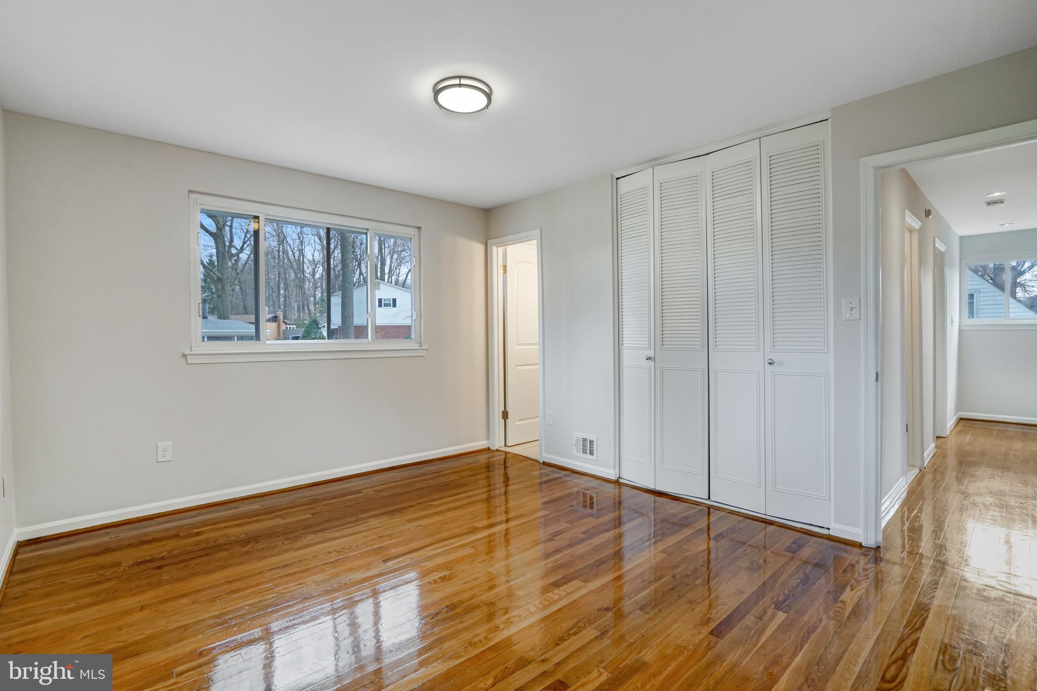 8941 Burke Lake Road Springfield, VA 22151 - Photo 13 of 34 a view of an empty room with wooden floor and a window