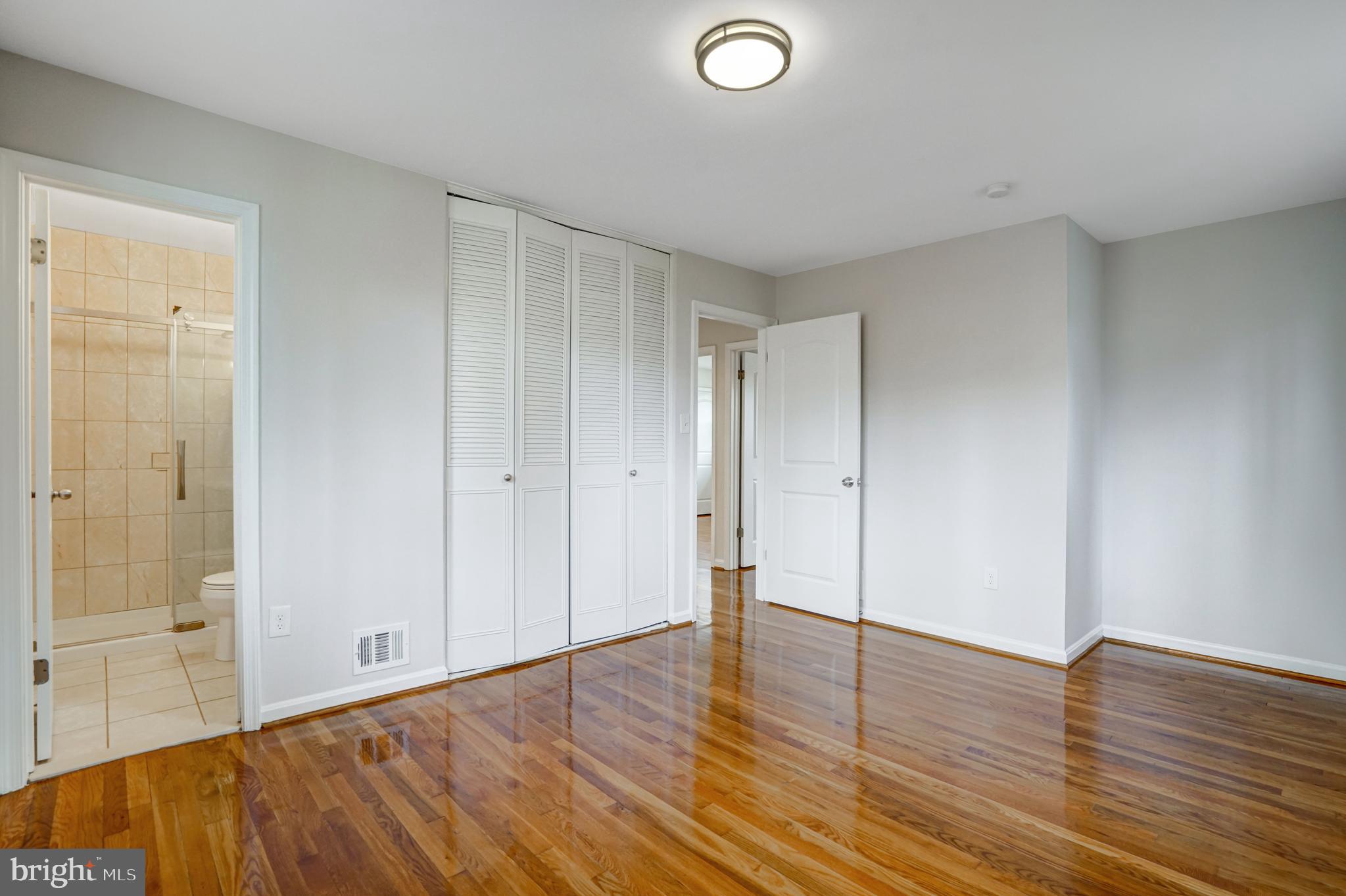 8941 Burke Lake Road Springfield, VA 22151 - Photo 16 of 34 a view of an empty room with wooden floor