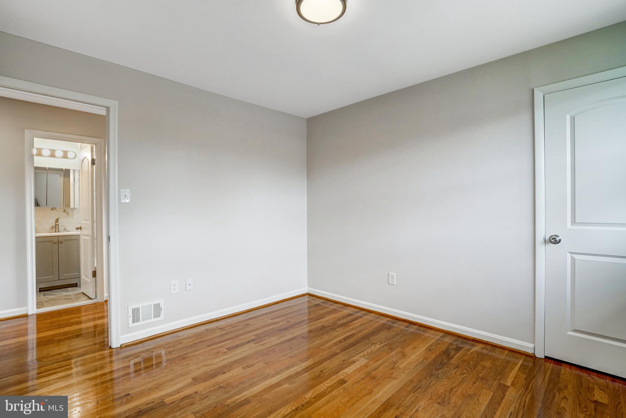 8941 Burke Lake Road Springfield, VA 22151 - Photo 22 of 34 a view of an empty room with wooden floor and closet