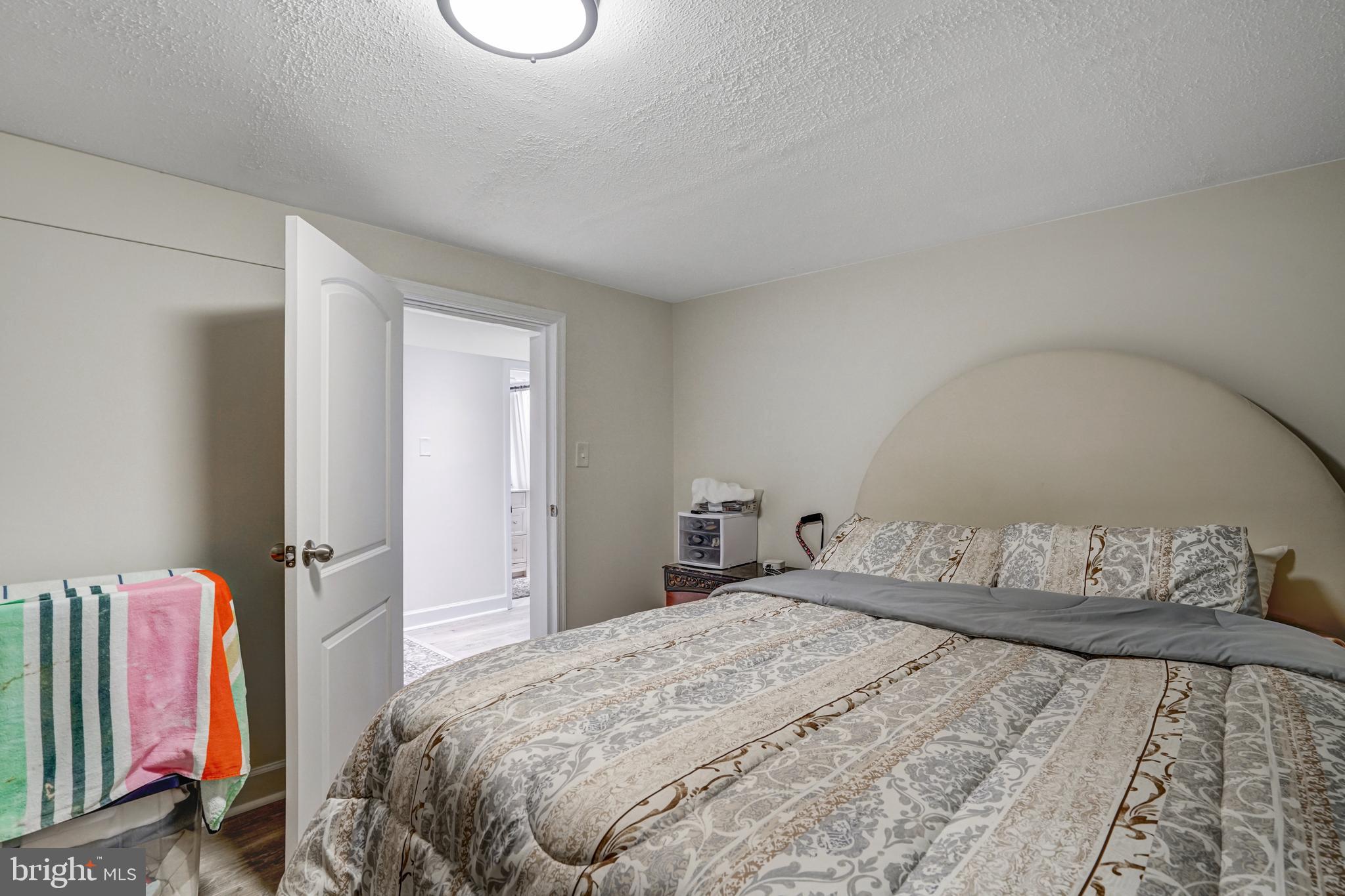 8941 Burke Lake Road Springfield, VA 22151 - Photo 30 of 34 a bedroom with a bed and a chandelier