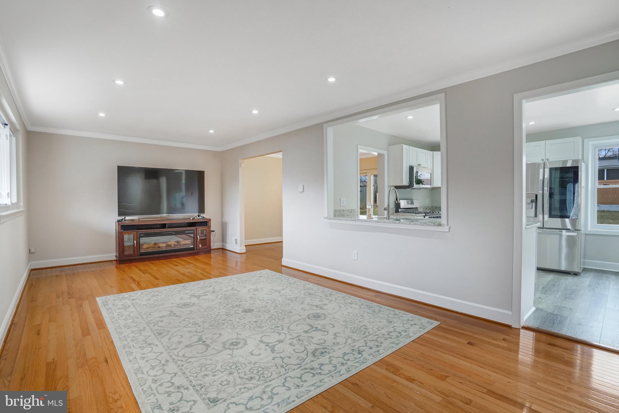 8941 Burke Lake Road Springfield, VA 22151 - Photo 3 of 34 a living room with furniture and a flat screen tv