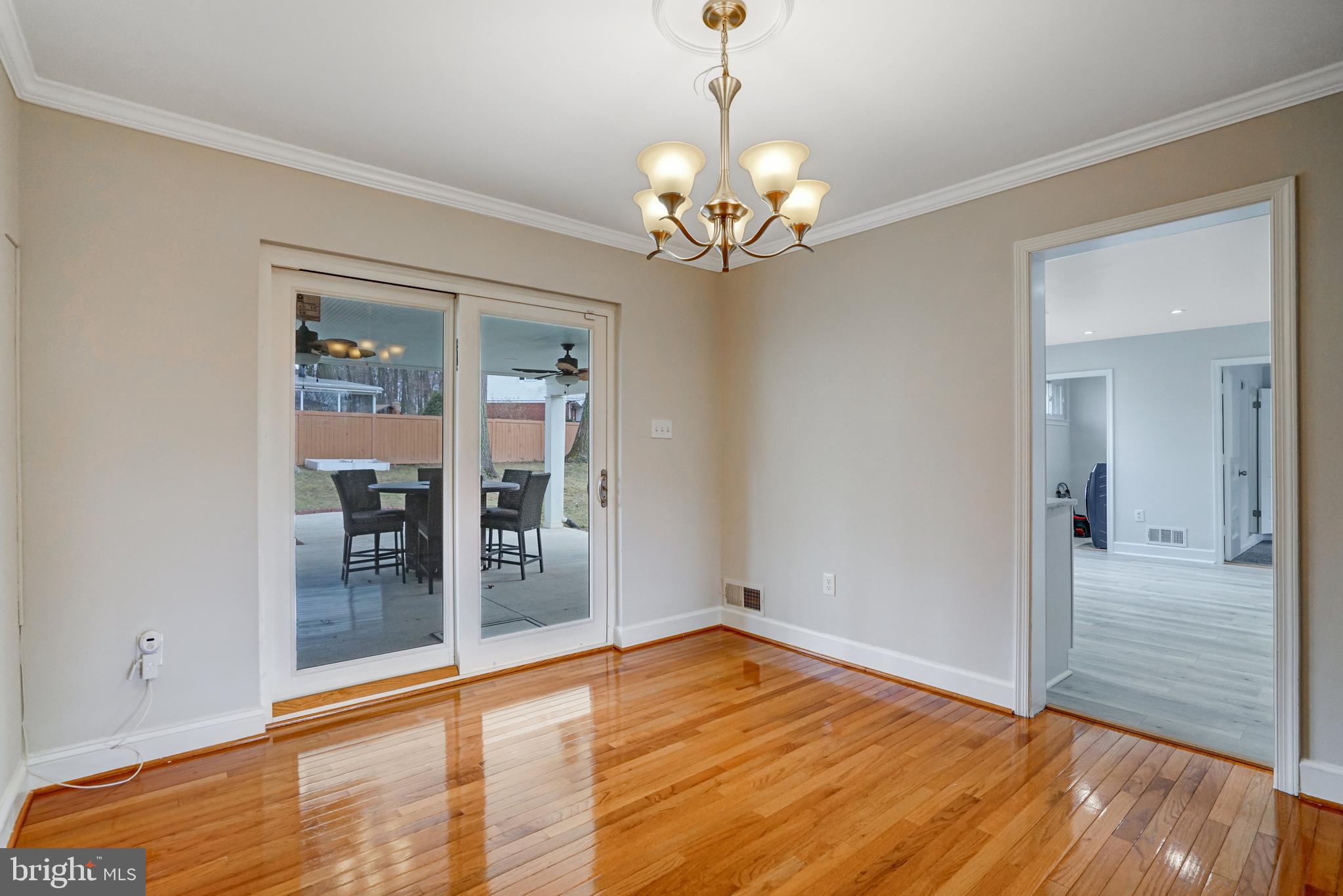 8941 Burke Lake Road Springfield, VA 22151 - Photo 7 of 34 a view of an empty room with window and wooden floor