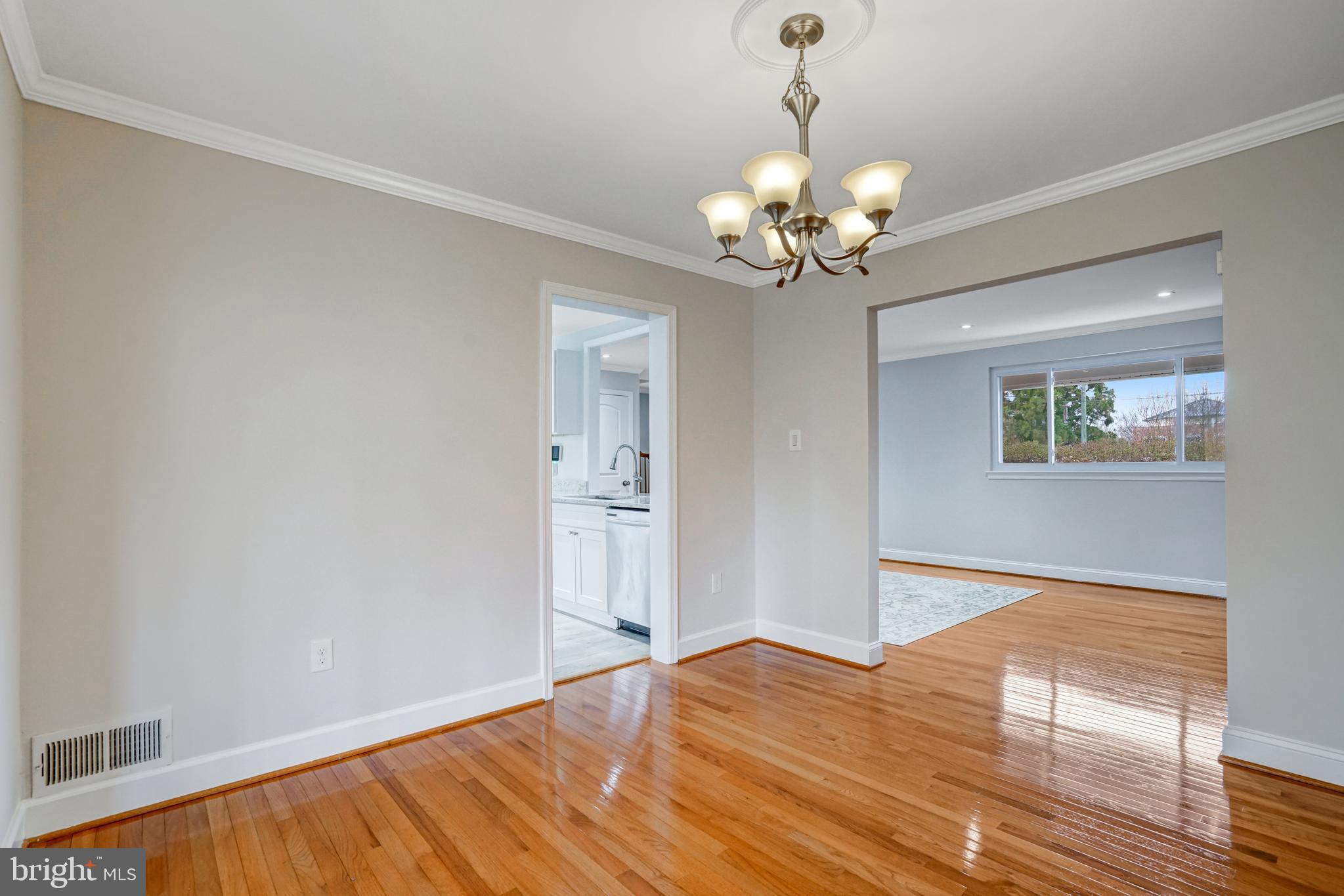8941 Burke Lake Road Springfield, VA 22151 - Photo 8 of 34 a view of a bedroom with wooden floor and a chandelier fan