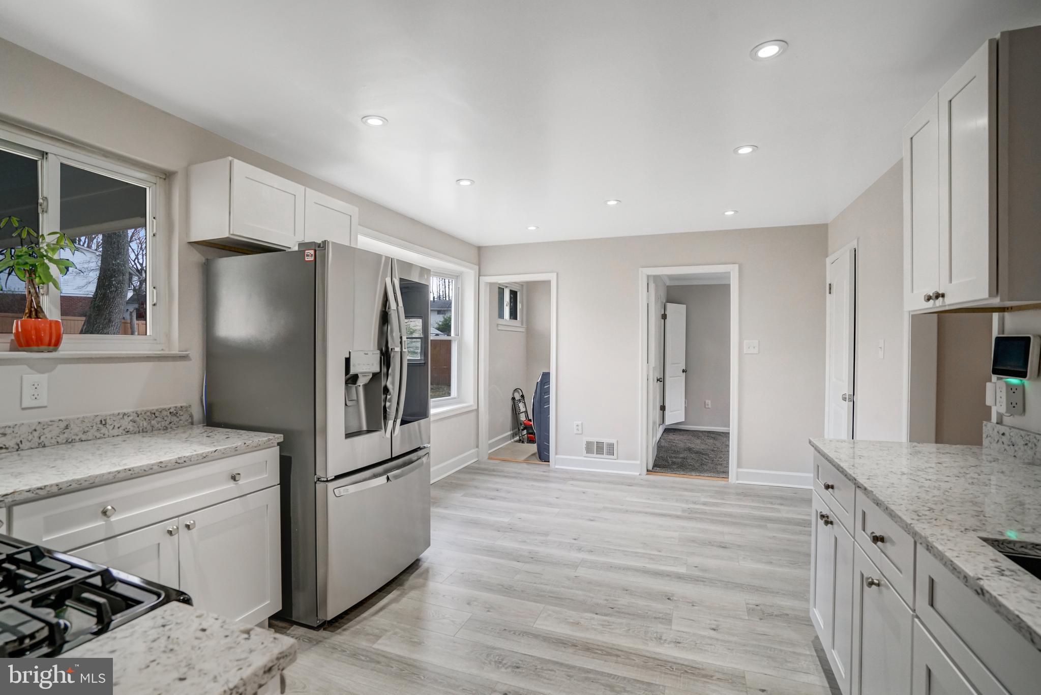 8941 Burke Lake Road Springfield, VA 22151 - Photo 9 of 34 a kitchen with stainless steel appliances granite countertop a refrigerator and a stove