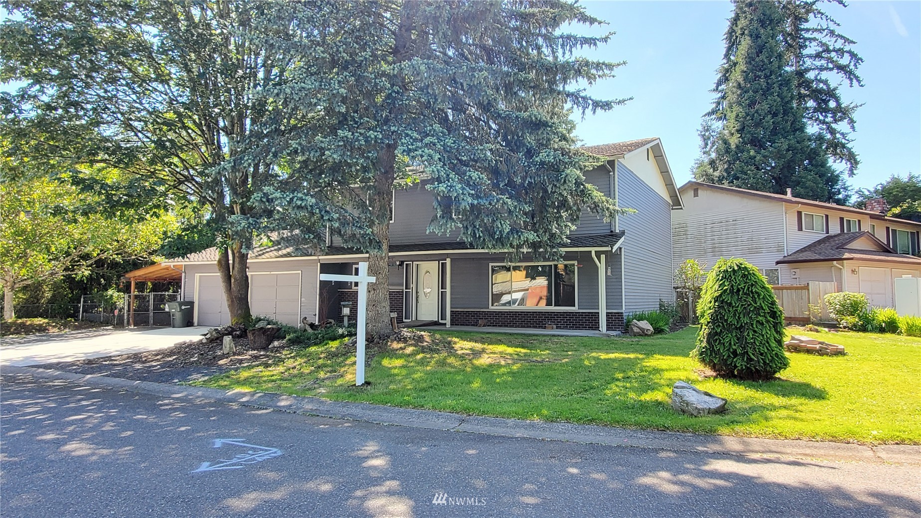 21603 9th Place West Bothell, WA 98021 - Photo 2 of 28 a front view of house with yard and trees around