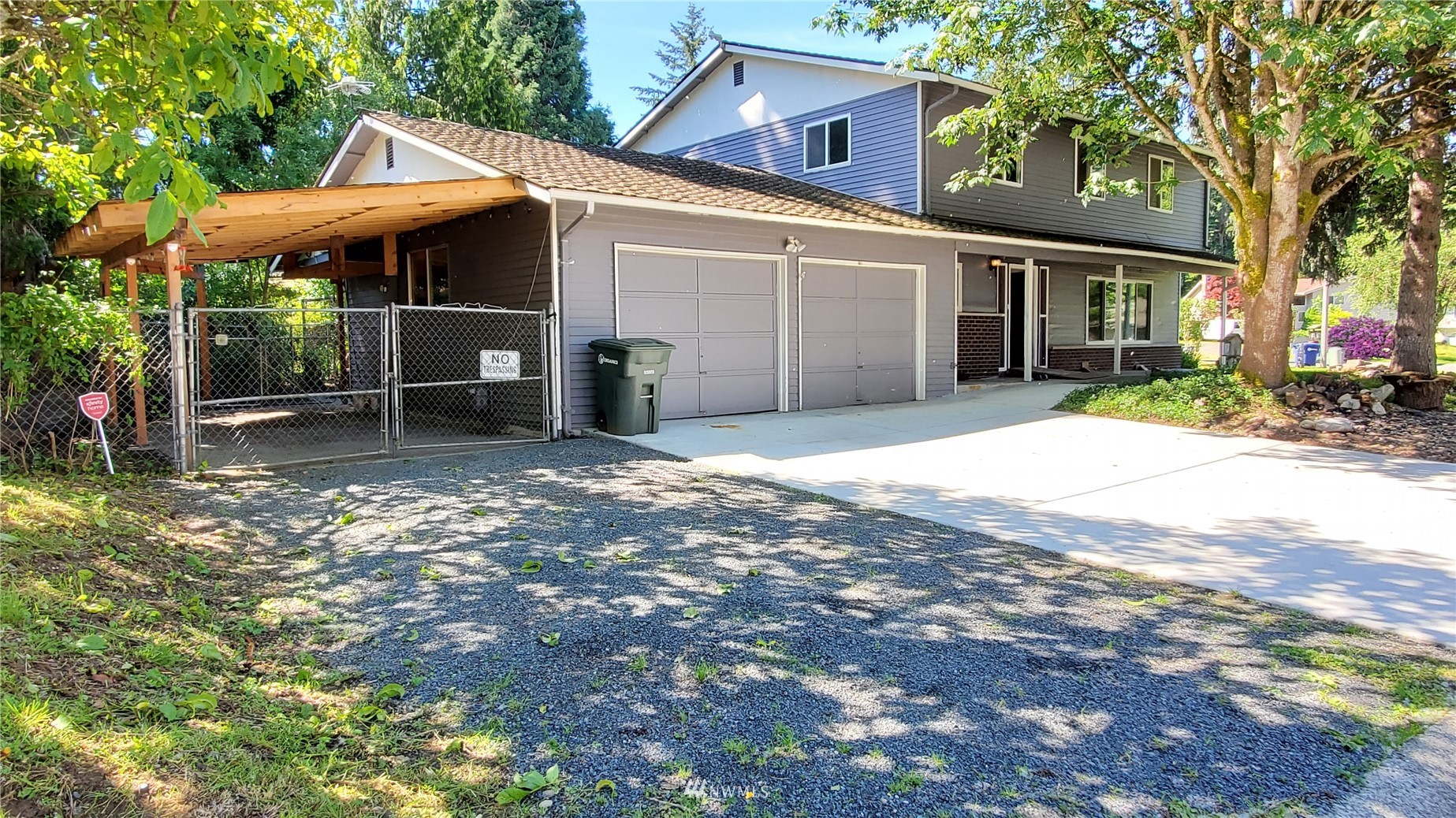 21603 9th Place West Bothell, WA 98021 - Photo 3 of 28 a view of a backyard with table and chairs under an umbrella