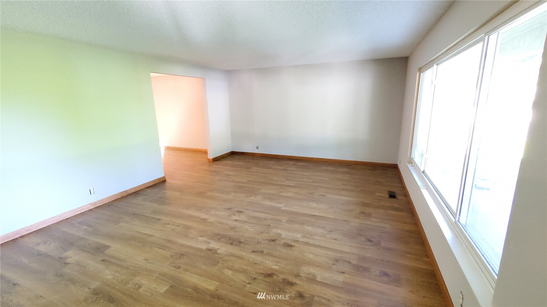 21603 9th Place West Bothell, WA 98021 - Photo 6 of 28 an empty room with wooden floor and windows