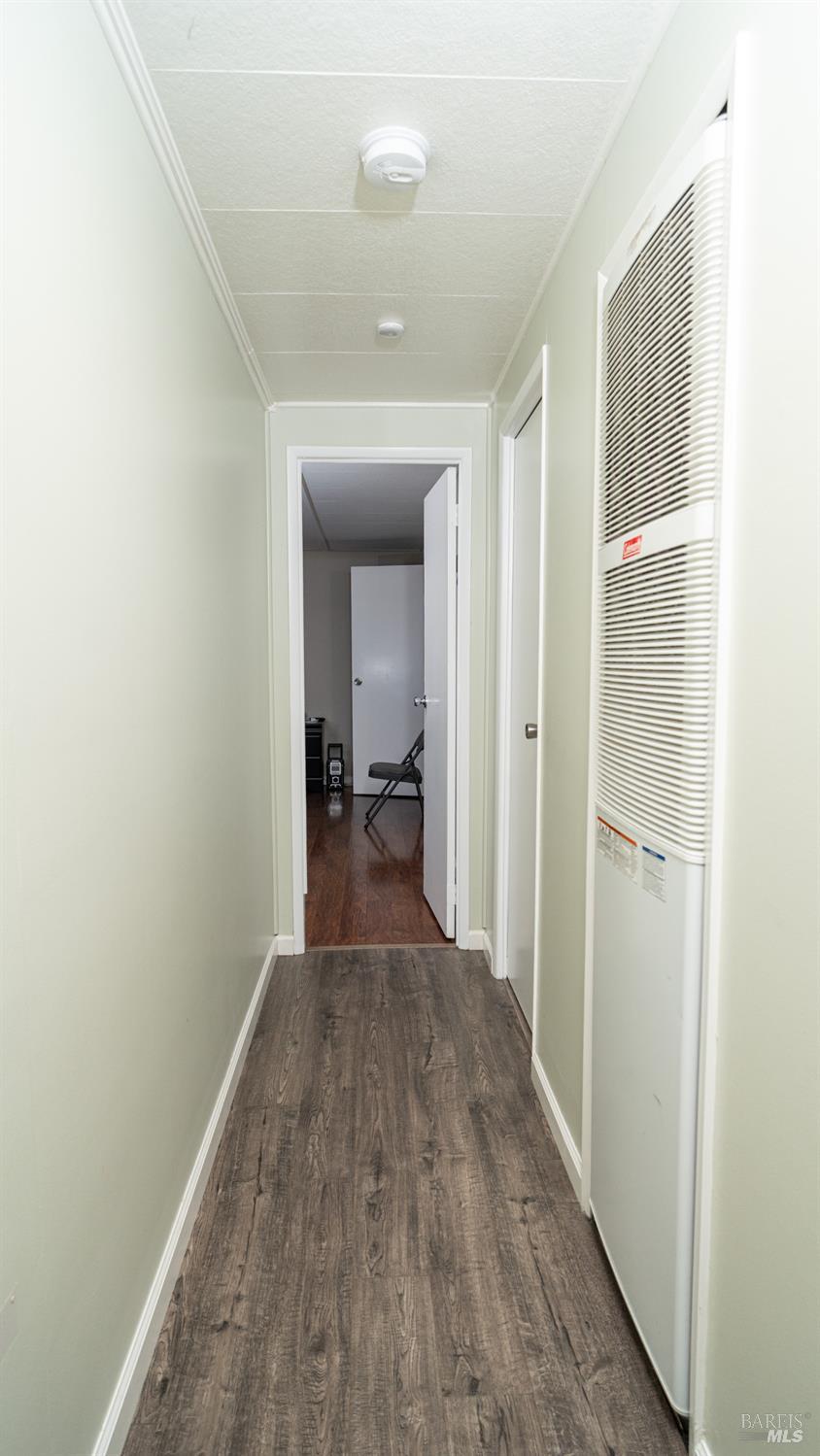 401 Frisbie Avenue Santa Rosa, CA 95407 - Photo 27 of 50 a view of a hallway with wooden floor and a bathroom